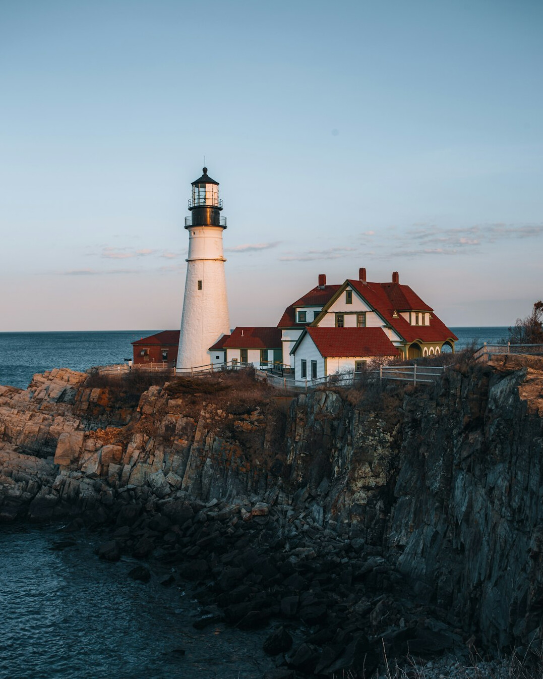 Rocky coastline with a lighthouse at sunset on the Uruguayan Atlantic coast in Rocha